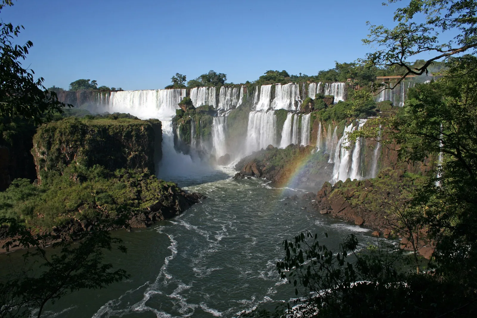 Broad cascades of Iguazú Falls framed by Atlantic Forest